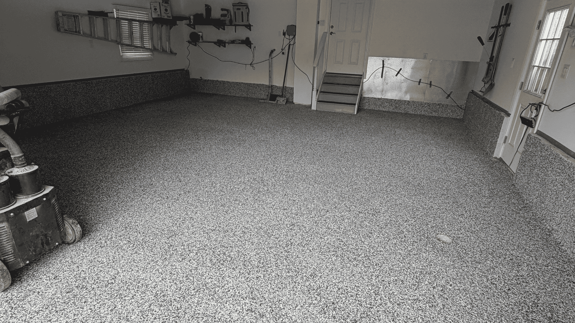 polyaspartic floor coating being poured and spread on concrete floor NJ